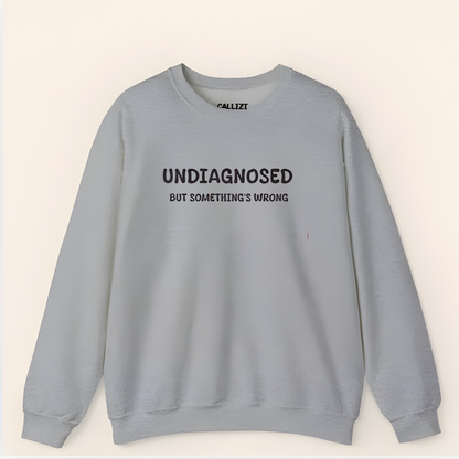 Unisex Black Graphic Sweatshirt – “Undiagnosed But Something’s Wrong” – Crewneck, Long Sleeve, Cotton‑Blend Fleece (S–XL)